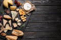 Different types of delicious cheese served on black wooden table, top view Royalty Free Stock Photo