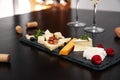 Different types of cheeses with berries and nuts on table Royalty Free Stock Photo