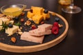 Different types of delicious cheeses, berries and nuts on table Royalty Free Stock Photo