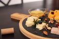 Different types of delicious cheeses, berries and nuts on table Royalty Free Stock Photo