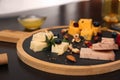 Different types of delicious cheeses, berries and nuts on table Royalty Free Stock Photo