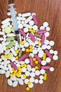 Different types of drugs are scattered on the table. Treatment of diseases with modern methods. Homeopathic and chemicals.