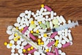 Different types of drugs are scattered on the table. Treatment of diseases with modern methods. Homeopathic and chemicals.
