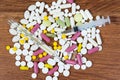 Different types of drugs are scattered on the table. Treatment of diseases with modern methods. Homeopathic and chemicals.