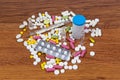 Different types of drugs are scattered on the table. Treatment of diseases with modern methods. Homeopathic and chemicals.
