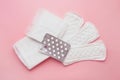 Different types of female pads and contraceptive tablets during the menstrual cycle on a pink background Royalty Free Stock Photo