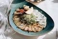 Different types of fish on a plate. Wedding table setting with food in restauran Royalty Free Stock Photo