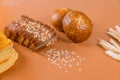 Different types of bread with grain on table