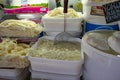 Different types of homemade cheese on display at farmer`s market