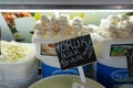 Different types of homemade cheese on display at farmer`s market