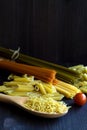 Different types of Italian pasta with a wooden spoon on a table with copy space Royalty Free Stock Photo