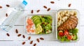 Different types of lunch boxes on a white wooden background. Top view, flat lay. Delicious healthy lunch. Royalty Free Stock Photo