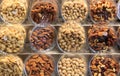 Different types of nuts in wooden displays in the Boqueria market.