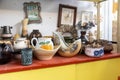 Different types of old vintage ceramic vases, jugs and figurines, paintings in a flea market shop