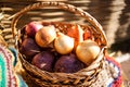 Different types of onions in a wicker basket. Autumn Harvest Royalty Free Stock Photo