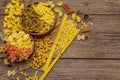 Different types of pasta in ceramic bowls. Traditional Italian food, healthy eating concept. Rustic wooden table Royalty Free Stock Photo