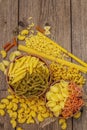 Different types of pasta in ceramic bowls. Traditional Italian food, healthy eating concept. Rustic wooden table Royalty Free Stock Photo