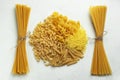 Different types of pasta shells long noodles and raw spaghetti top view