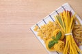 Different types of pasta on wooden table, top view. Space for text Royalty Free Stock Photo