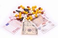 Different types of pills are located in dollars, euros and pounds sterling Royalty Free Stock Photo