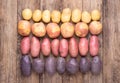 Different types of potatoes on wooden rustic table