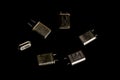 Different types of quartz resonators. Isolated on black background. Electronic components.