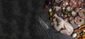 Different types of raw meat: beef, chicken, pork, turkey gilberts with vegetables and greens on black marble table. Panoramic,