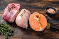 Different types of raw meat steaks Beef striploin, salmon and chicken breast. Dark wooden background. Top view Royalty Free Stock Photo