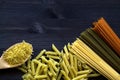 Different types of raw pasta on a wooden table Royalty Free Stock Photo