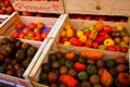 Different types of red, yellow and black provencal french ripe fresh tomatoes in wooden fruit boxes on farmer market - Provence, Royalty Free Stock Photo