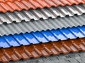 Different types of roof coating. Background from layers of sheet metal  profiles, ceramic tiles, asphalt roofing shingles and Royalty Free Stock Photo