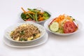 3 different types of salads: fried rice (arroz chaufa), fresh salad (tomatoes, cabage), brocoli salad