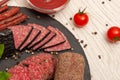 Different types sliced sausage on a graphite board with ketchup. top view Royalty Free Stock Photo