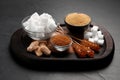 Different types of sugar on black table, closeup Royalty Free Stock Photo