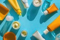 Different types of sunscreen creams on a blue background. Suitable for beauty and skincare concepts Royalty Free Stock Photo