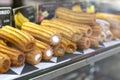Different types of traditional sweet spanish dessert churros with filling on the market or bakery showcase. Hot baked Royalty Free Stock Photo