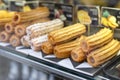 Different types of traditional sweet spanish dessert churros with filling on the market or bakery showcase. Hot baked Royalty Free Stock Photo