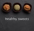 l candies from dried fruits Energy balls on a black background Royalty Free Stock Photo