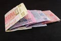 Different Ukrainian hryvnias on a black background. Royalty Free Stock Photo