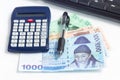 Different value South korean currency bill near calculator pen and keyboard, save money concept