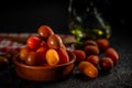 Different varieties of cherry pear tomato on dark background