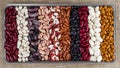 Different varieties of kidney beans against the background of the rough texture of burlap Royalty Free Stock Photo