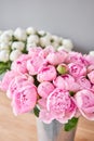 Different varieties of peonies in a metal vases. Beautiful peony flower for catalog or online store. Floral shop concept