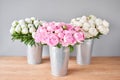 Different varieties of peonies in a metal vases. Beautiful peony flower for catalog or online store. Floral shop concept