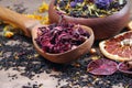 Assortment of dry tea. different varieties of tea on a wooden table. blended tea with flower petals, hibiscus in a wooden spoon an Royalty Free Stock Photo