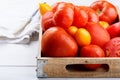 Different varieties of tomatoes on a wooden tray. Colorful red and yellow fresh ripe tomatoes Royalty Free Stock Photo