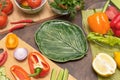 Different vegetables for cooking and empty plate in the form of green leaf. Diet, fasting, vegan, vegetarian, healthy raw food Royalty Free Stock Photo