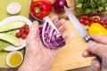 Different vegetables for cooking healthy vegetarian vegan diet food. Chef hands in cellophane gloves cutting violet cabbage Royalty Free Stock Photo