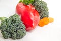 Different vegetables and fresh herbs with waterdrops on the white table.