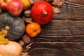 Different vegetables, pumpkins, apples, pears, nuts, tomatoes, corn, dry yellow leaves on wooden background. Autumn mood, copy Royalty Free Stock Photo